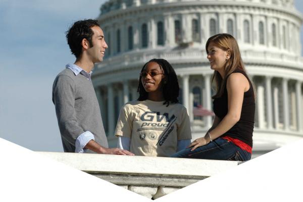 Three students talking with the U.S. Capitol Building in the background